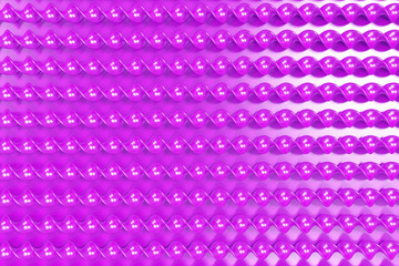 Violet plastic spiral sticks on violet background