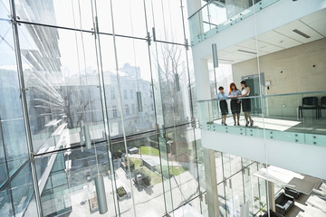 Businesswomen discussing at office balcony