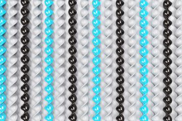 Black, white and blue plastic spiral sticks on white background