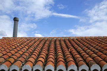 roof tile with chimney against blue sky