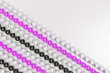 Black, white and violet plastic spiral sticks on white background