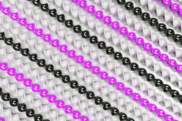 Black, white and violet plastic spiral sticks on white background