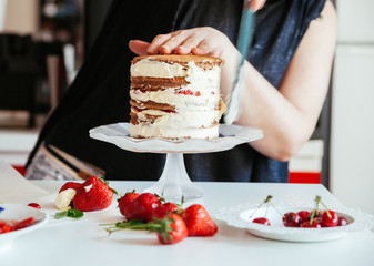 Woman Carefully Icing The Cake