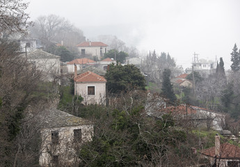 Fog above traditional houses in Milies village on mountain Pelion.Greece