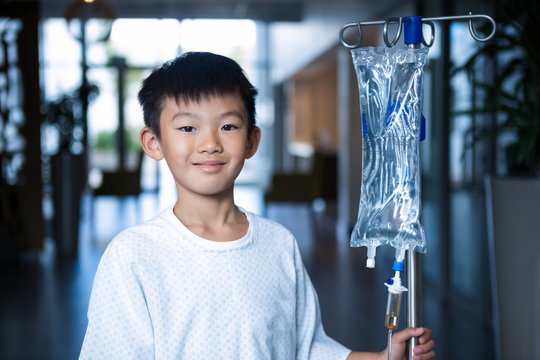 Smiling Boy Patient Holding Intravenous Iv Drip 