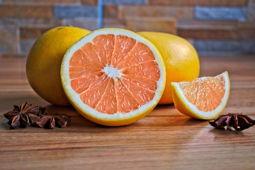 Closeup of grapefruits and star anise on a wooden table