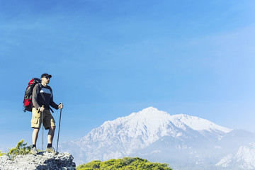 Fototapeta premium Summer hiking in the mountains with a backpack and tent.
