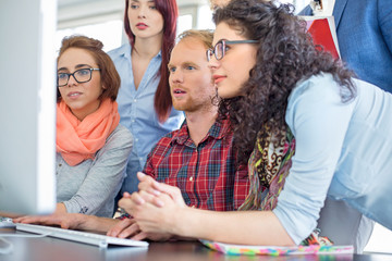 Business people working together on computer in office