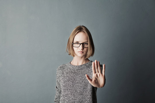 Closeup portrait woman with bad attitude giving talk to hand gesture with palm outward