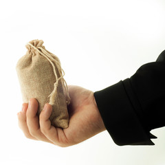 Obraz premium &nbsp;Man holds burlap bag in one hand