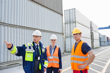 Workers discussing in shipping yard