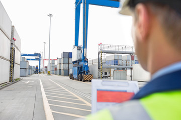 Male supervisor with clipboard in shipping yard