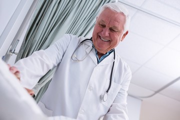 Doctor consoling senior patient