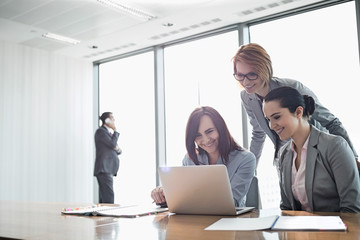 Businesswomen using laptop in office