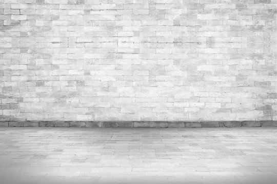 Abstract white interior of empty room with concrete wall and floor and picture frame of old vintage White brick wall