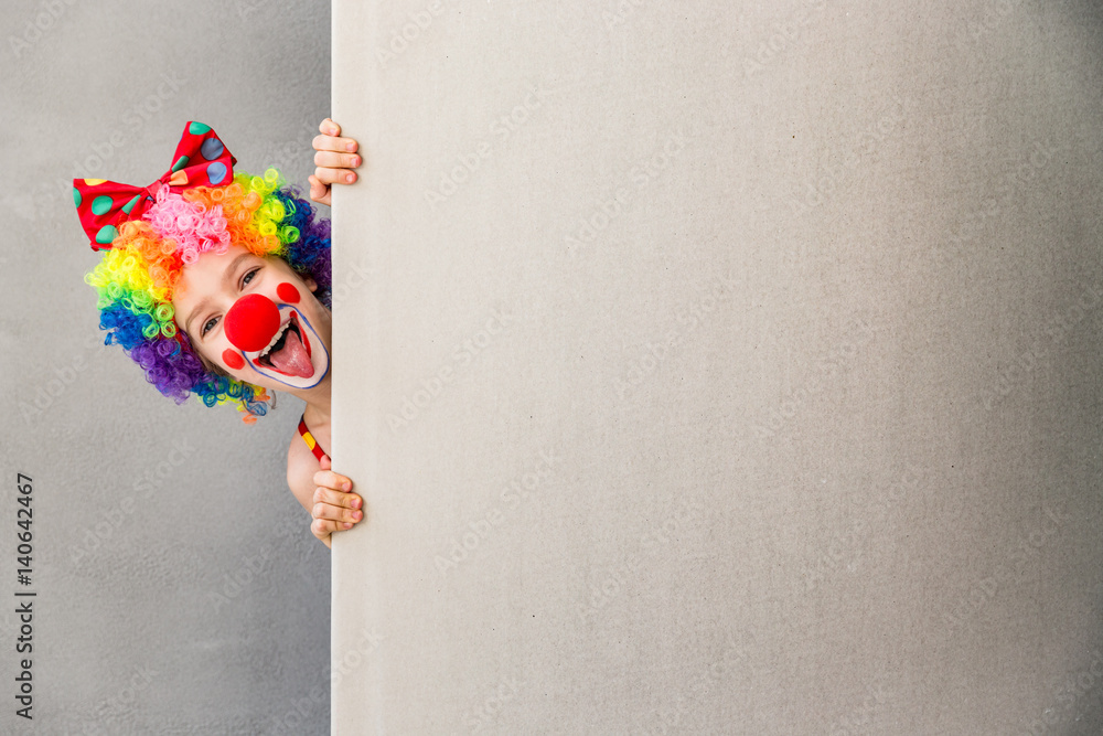 Wall mural Funny kid clown playing indoor