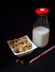 Healthy breakfast - milk and musli on dark background