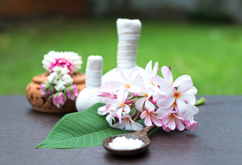 Fototapeta na wymiar Spa massage compress balls, herbal ball and treatment spa, Thailand, select focus flower.