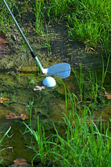 Man chipping ball from water hazard