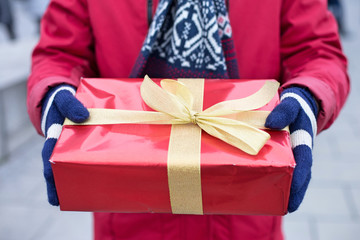 Midsection of man holding gift box winter