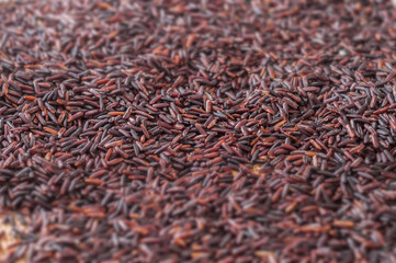 Black raw rice background with selective focus