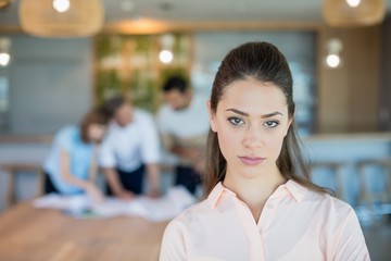 Beautiful business executive standing in office