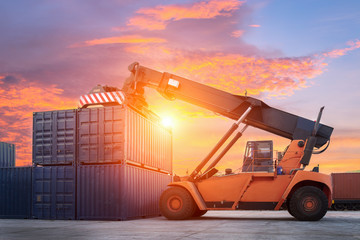 Obraz premium Forklift handling container box loading to freight train in import and export