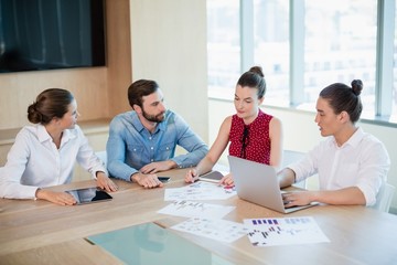 Business executives discussing with each other 