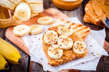 Peanut butter toast with banana slices and flax seeds
