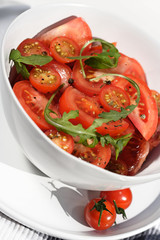 Close  - up of sliced tomatoes with rucola
