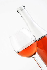 Close-up of rose wine on white background