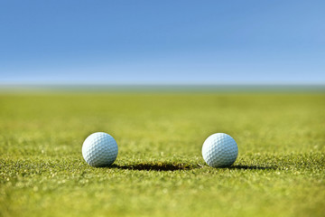 Golf balls near hole