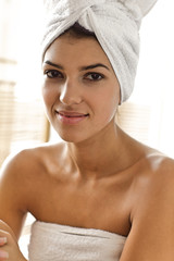 Portrait of young woman wrapped in towel