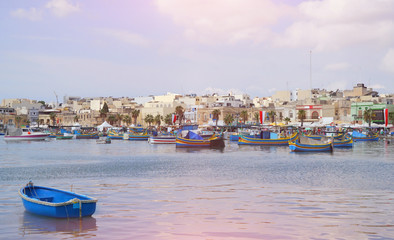 Sunset in the village of fishermen. Marsaxlokk in Malta. View of an ancient city from the sea.
Traditional maltese boat Luzzu