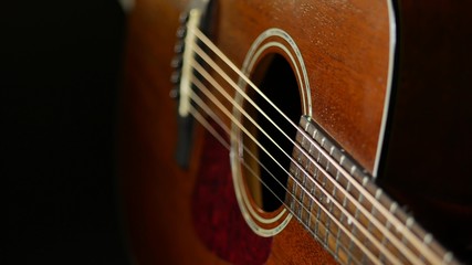 Acoustic guitar on wood background. Close up of music instrument