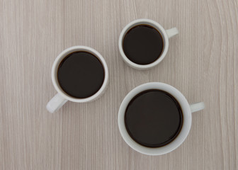 Cups of coffee on a wooden table