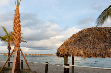 Fishing Peer at Dania Beach at Sun Set with Palm Trees at Foreground, Fort Lauderdale, Florida, USA. 