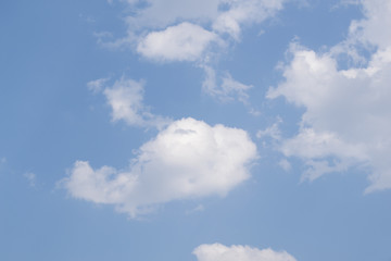 White fluffy clouds in  blue sky and space