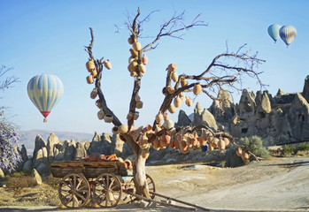 Landscape with jugs on a tree and old wagon full of clay pots, Cappadocia in Turkey