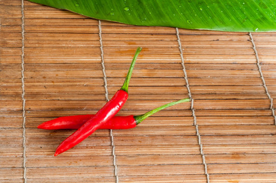Chili peppers on bamboo table surface