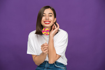 The young woman with colorful lollipop