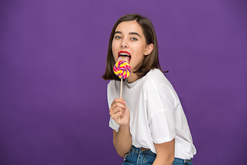 The young woman with colorful lollipop