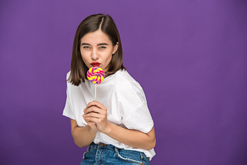 The young woman with colorful lollipop