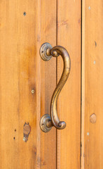 Vintage elegant curved handle on wooden door