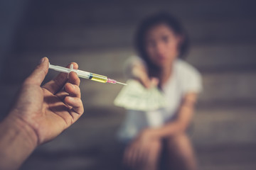 Drug addict young woman with syringe in action, Drug abuse concept.,