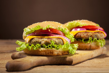 Fresh burgers on wooden background