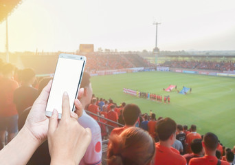 Woman hands using mobile smartphone on Football stadium