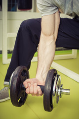 Fototapeta na wymiar Sporty man lift weights at the gym