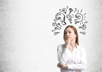 Pensive blond woman and question marks, concerete