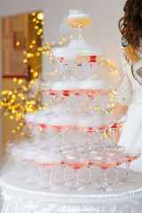 Fototapeta na wymiar A pyramid of champagne glasses with a cherry